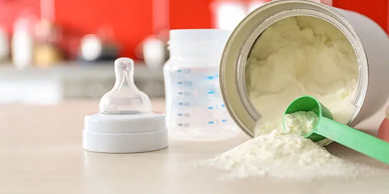Baby milk formula on kitchen background